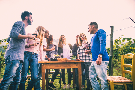 Group of friends at restaurant outdoors - People having dinner in a home gardenの写真素材