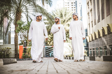 Three arabic men bonding outdoors - Businesspeople walking and talking in Dubaiの写真素材