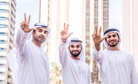 Three arabic men bonding outdoors - Businesspeople walking and talking in Dubaiの写真素材