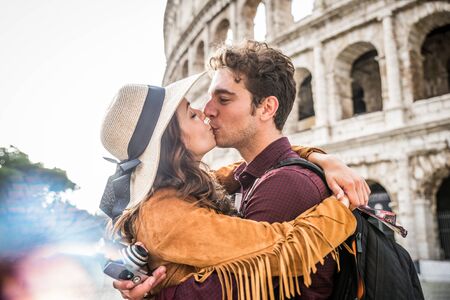Young couple at the Colosseum, Rome - Happy tourists visiting italian famous landmarksの写真素材