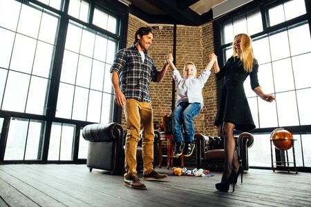 Family home portrait. Parents and son spending time togetherの写真素材