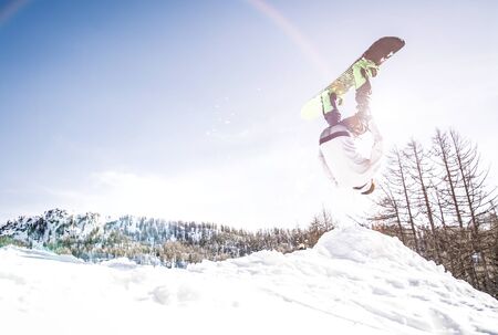 Snoboarder performing tricks on the snowの写真素材