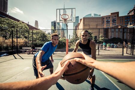 Two street basketball players playing hard on the courtの写真素材