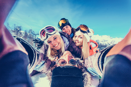 Group of friends with ski on winter holidays - Skiers having fun on the snowの写真素材