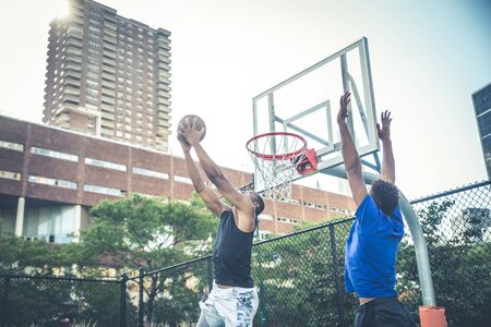 Two afroamerican athlethes playing basketball outdoors - Basketball athlete training on court in New...