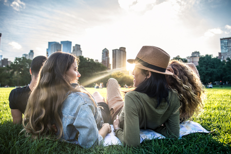 Multi-ethnic group of friends in Central Park, Manhattan - Young cheerful people bonding outdoorsの写真素材