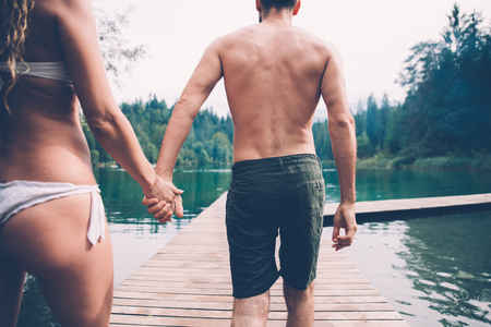 Young couple kissing in front beautiful lake landscapeの写真素材