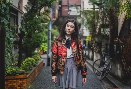 Beautiful japanese girl walking in Tokyo. Concept about teenagers and schoolの写真素材