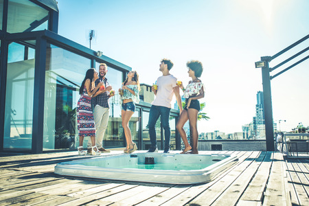 Multi-ethnic group of friends having party on  rooftop - Happy people bonding and having funの写真素材