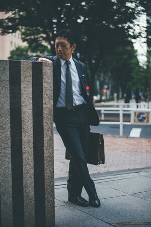 Senior business man moments on the streets of Tokyo