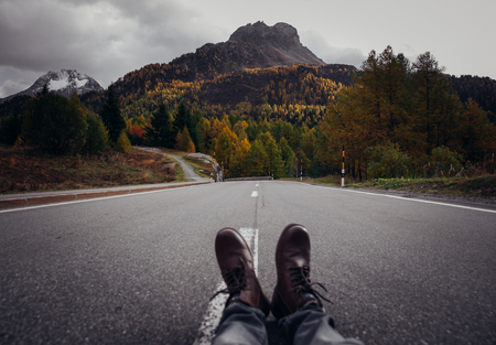 Man taking photos from the middle of the road