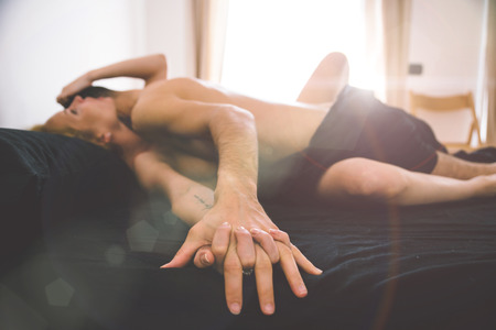 Young couple romantic moments in bed roomの写真素材