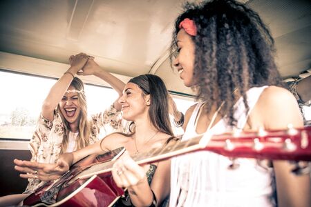 Hippie friends driving on a minivanの写真素材