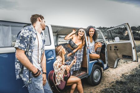 Group of friends travelling with a vintage minivan - Hippies driving into the nature
