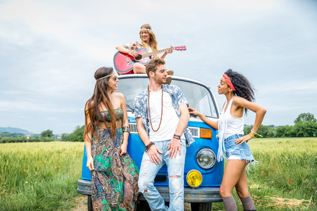 Group of friends travelling with a vintage minivan - Hippies driving into the natureの写真素材