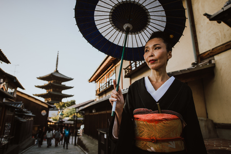 Beautiful japanese senior woman walking in the village. Typical japanese traditional lifestyleの写真素材