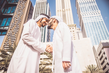 Three arabic men bonding outdoors - Businesspeople walking and talking in Dubaiの写真素材