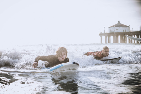 Group of friends going to surf at the beach