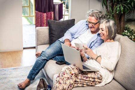 Senior Couple Using Laptop At Homeの写真素材