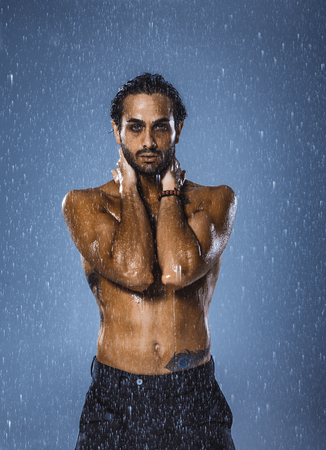 Man having fun under the rainの写真素材