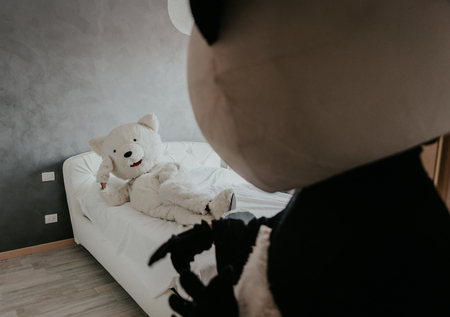 Men with animal costumes spending time inside the houseの写真素材