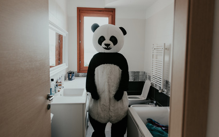 Men with animal costumes spending time inside the houseの写真素材