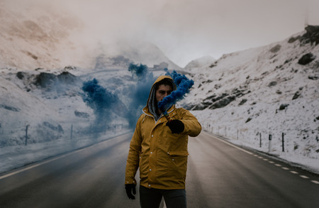 Explorer walking on a street in the middle of snowy landscapeの写真素材