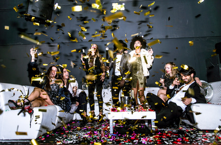 Multi-ethnic group of friends celebrating in a nightclub - Clubbers having partyの写真素材