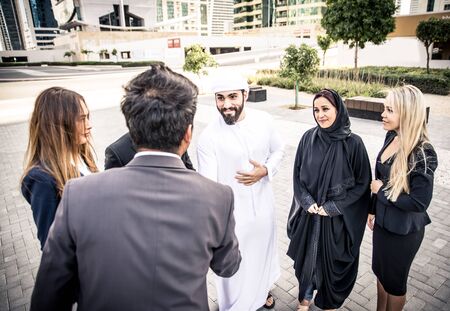 Arabic and western business people speaking about investments