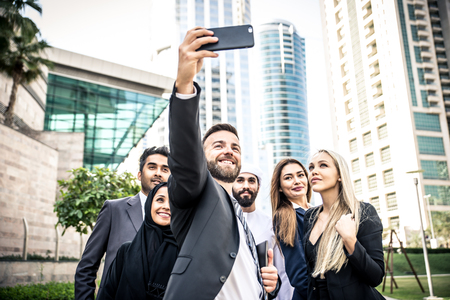 Arabic and western business people taking selfieの写真素材