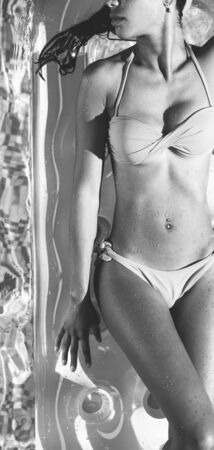 Beautiful woman body on an airbedの写真素材