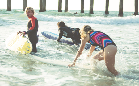 Three surfers practicing in the ocean