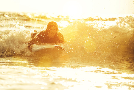 Surfer boy ready to get on the board