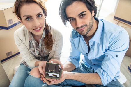Couple moving to a new home - Happy married people buy a new apartment to start new life togetherの写真素材
