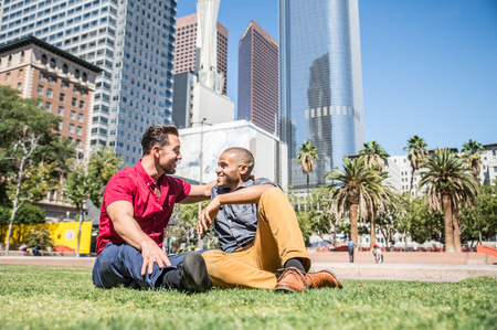 Homosexual couple at a romantic date outdoors - Gay couple in love flirting and having funの写真素材