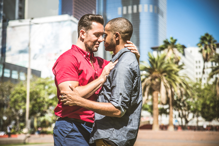 Homosexual couple at a romantic date outdoors - Gay couple in love flirting and having funの写真素材