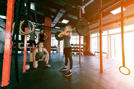 Muscular athletes training in a crossfit gym - Functional training workout in a gymの写真素材
