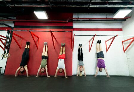 Muscular athletes training in a crossfit gym - Functional training workout in a gymの写真素材