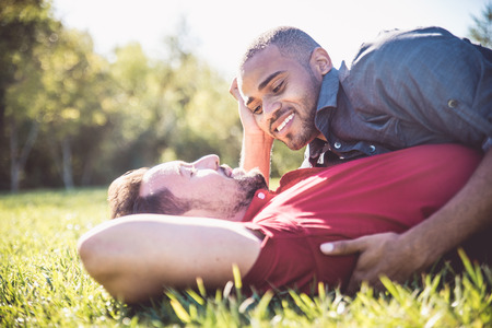 Homosexual couple at a romantic date outdoors - Gay couple in love flirting and having funの写真素材