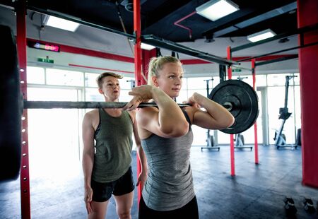 Muscular athletes training in a crossfit gym - Functional training workout in a gymの写真素材