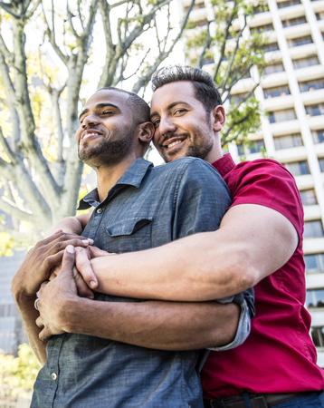 Homosexual couple at a romantic date outdoors - Gay couple in love flirting and having funの写真素材