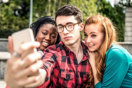 Multi-ethnic group of teenagers taking a selfieの写真素材