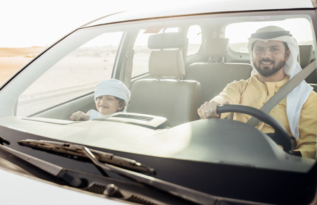 Father and son spending time, driving in the desertの写真素材