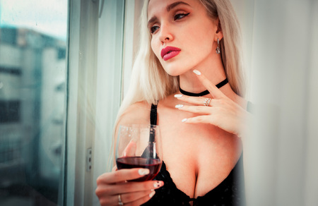 Beautiful blonde woman posing in her bedroomの写真素材