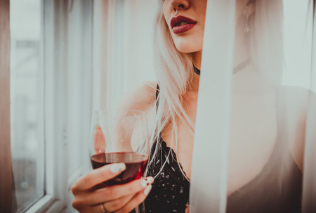 Beautiful blonde woman posing in her bedroomの写真素材