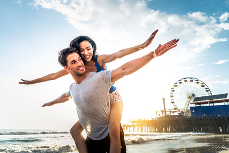 Couple of lovers on a romantic date at the beach at sunsetの写真素材
