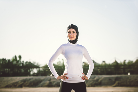 Arabic woman running outdoor and wearing hijabの写真素材