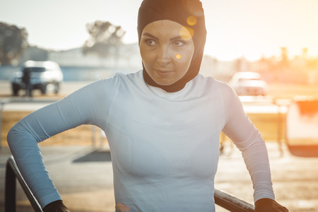 Arabic woman running outdoor and wearing hijab