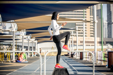 Arabic woman running outdoor and wearing hijabの写真素材