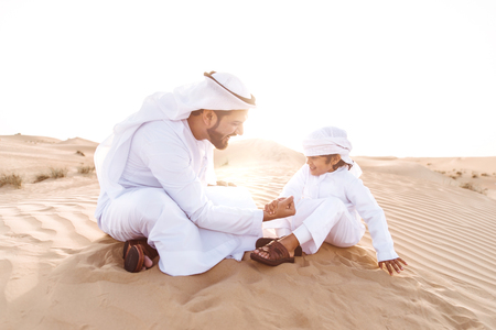 Father and son spending time in the desertの写真素材